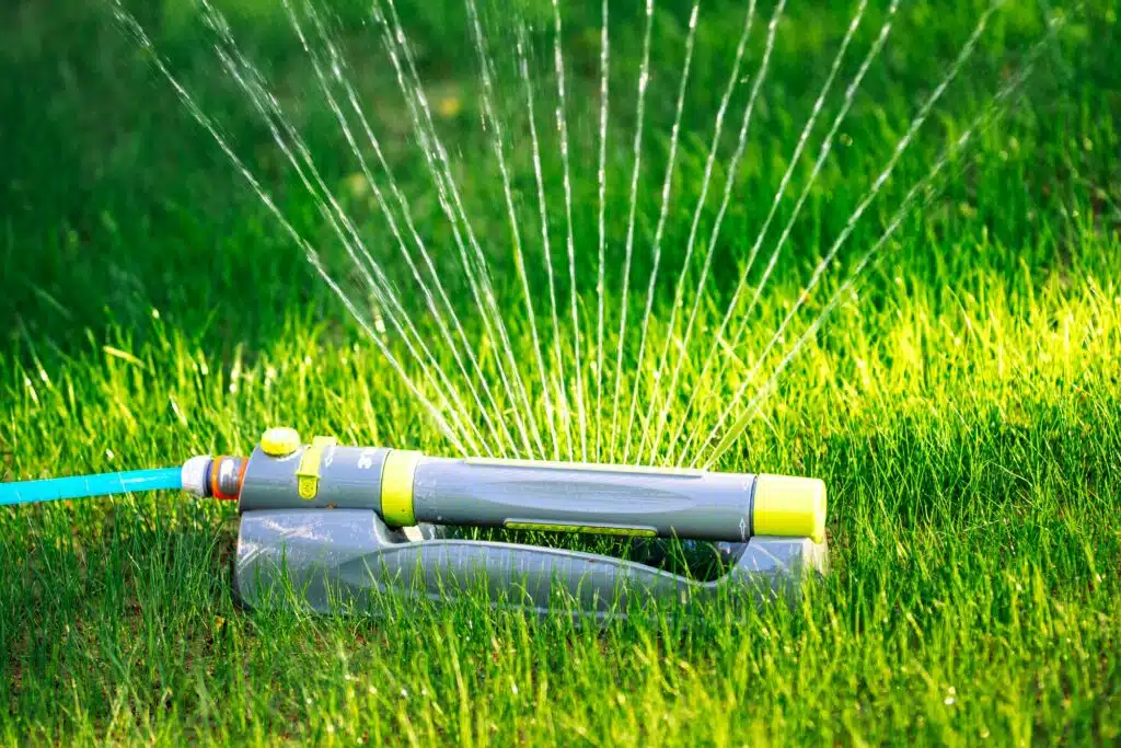 Modern sprinkler working on grass irrigation. Multiple sprinkler system watering the fresh lawn
